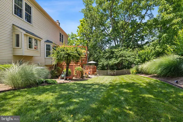 a view of a wooden fence under a large tree