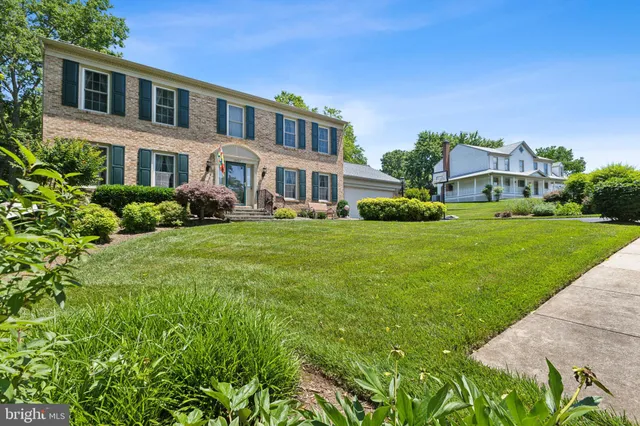 a front view of a house with a garden and plants