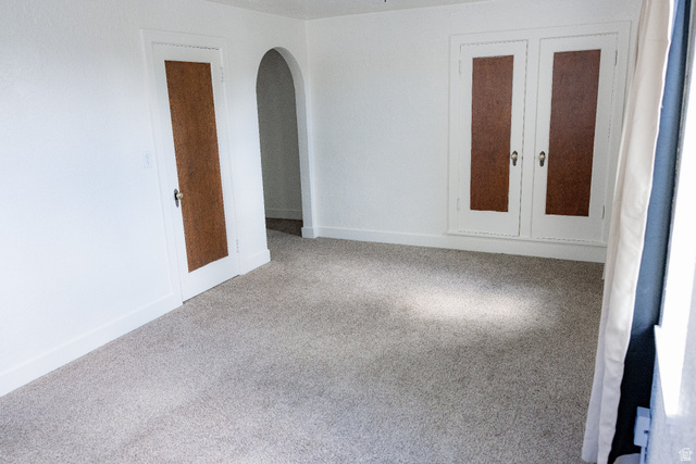 69 South Main Street Manti, UT 84642 - Photo 29 of 44 Spacious room featuring light-toned carpet flooring, white painted walls, and white trim