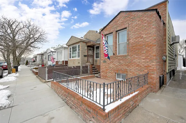 a view of a house with wooden fence