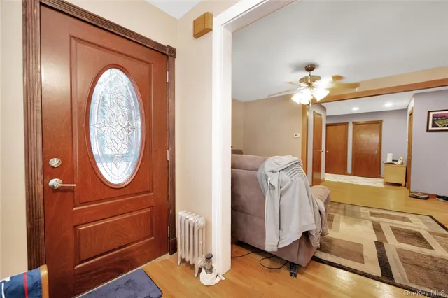 a view of hall way with furniture and a mirror