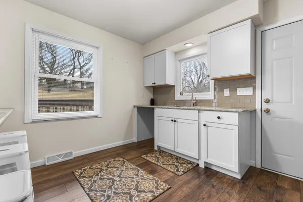 a kitchen with a stove a sink and a refrigerator