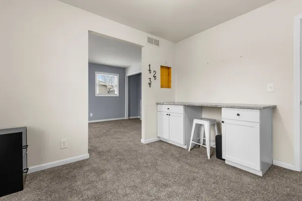 a view of room with window and cabinet