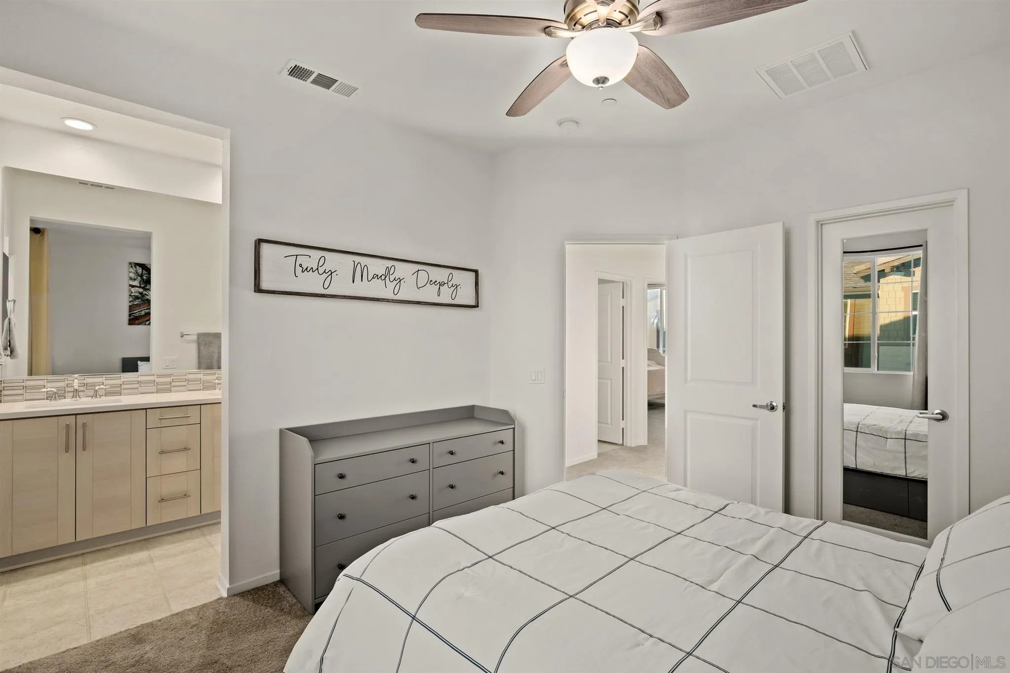 1150 Via Lucero Oceanside, CA 92056 - Photo 11 of 36 a bedroom with a bed and a chandelier