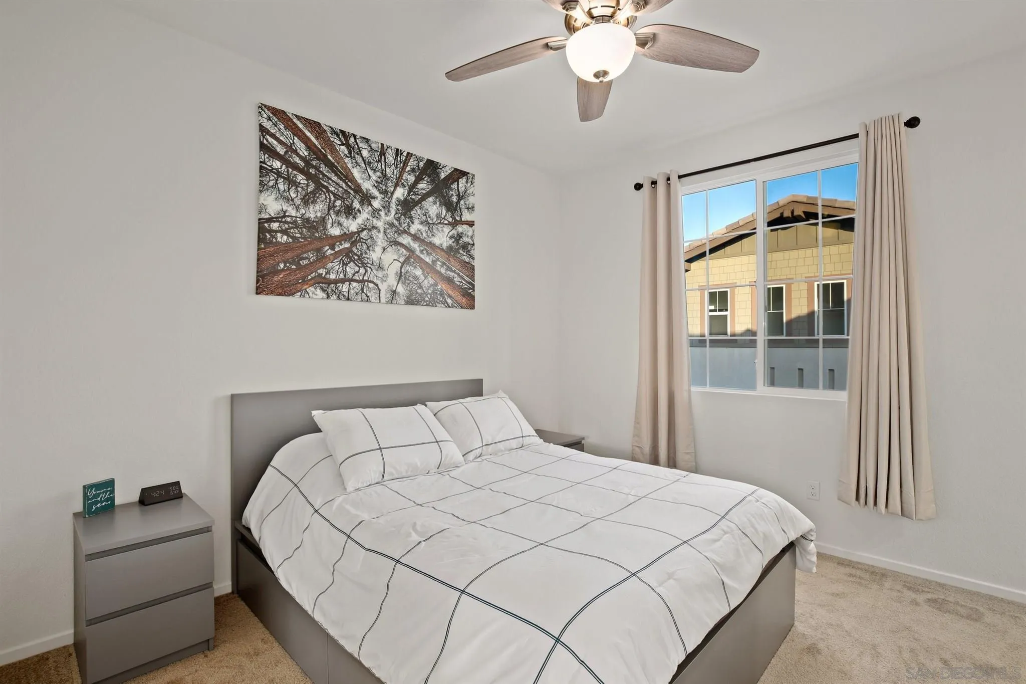1150 Via Lucero Oceanside, CA 92056 - Photo 12 of 36 a bedroom with a large bed and a chandelier