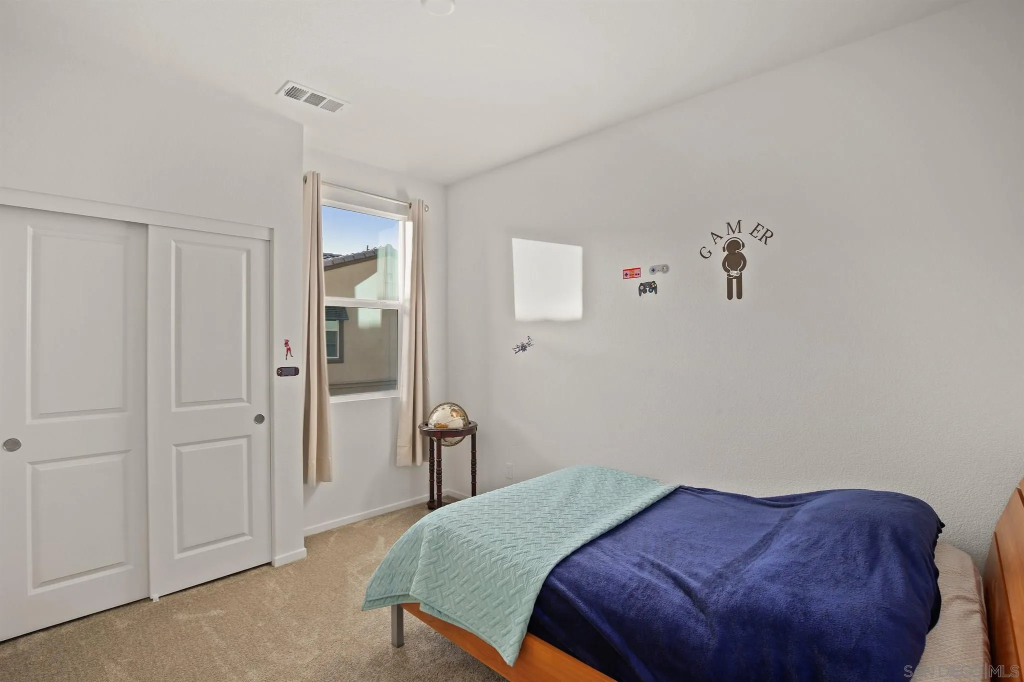 1150 Via Lucero Oceanside, CA 92056 - Photo 13 of 36 a bedroom with a bed and a painting on the wall