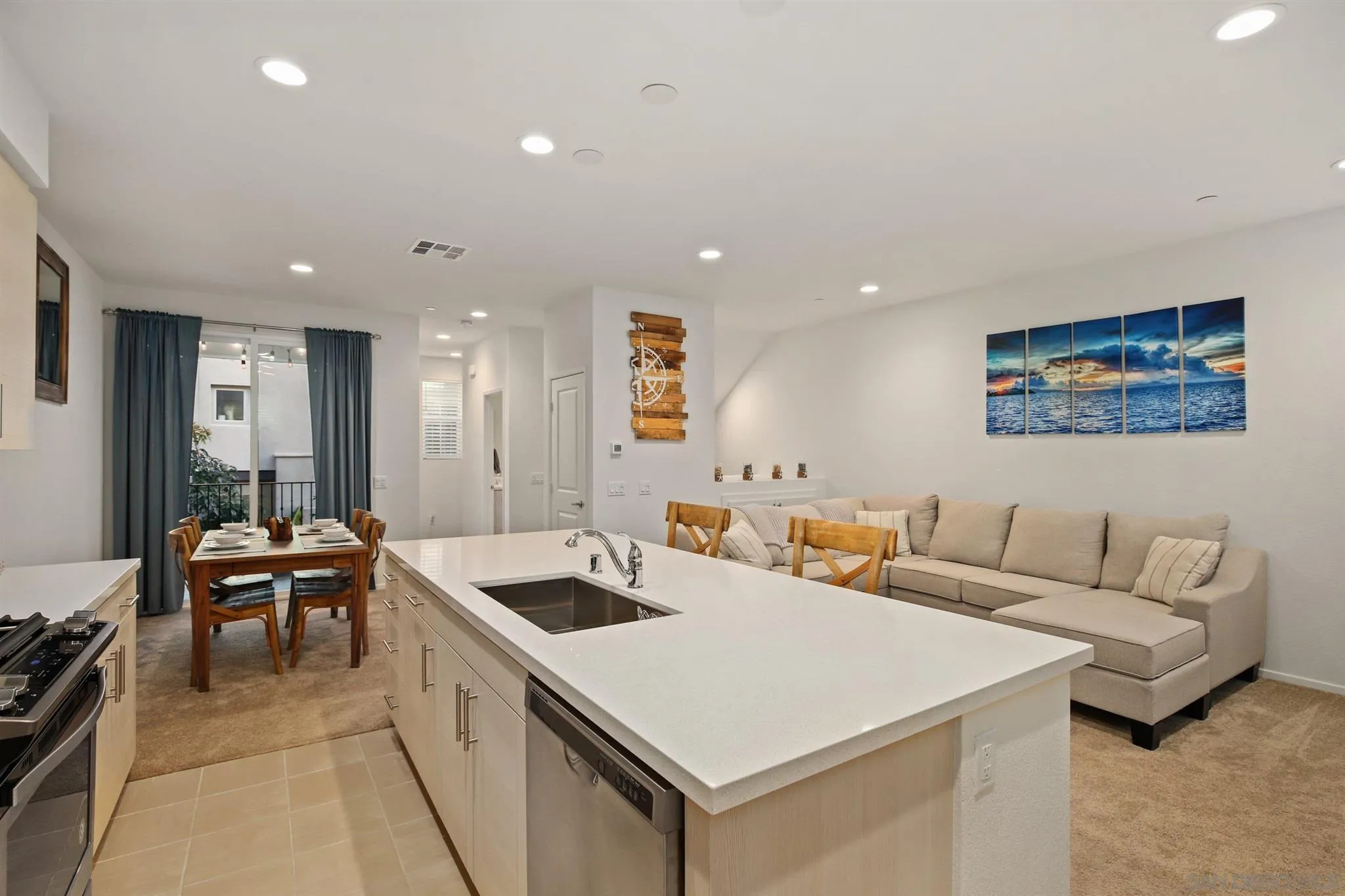 1150 Via Lucero Oceanside, CA 92056 - Photo 20 of 36 a living room with furniture and a refrigerator
