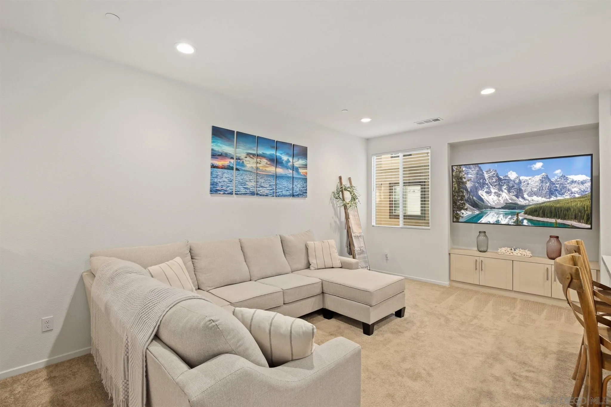 1150 Via Lucero Oceanside, CA 92056 - Photo 24 of 36 a living room with furniture and a flat screen tv