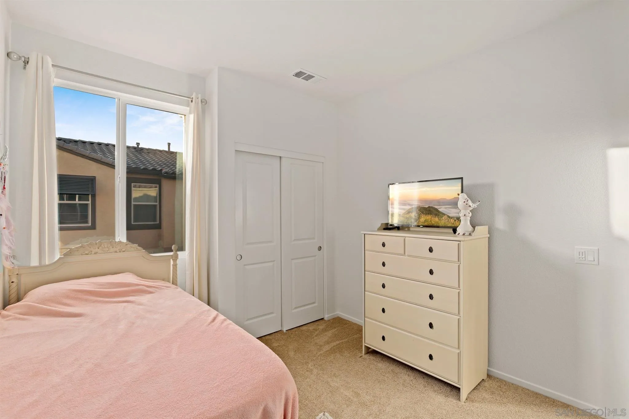 1150 Via Lucero Oceanside, CA 92056 - Photo 9 of 36 a bedroom with a bed and a dresser