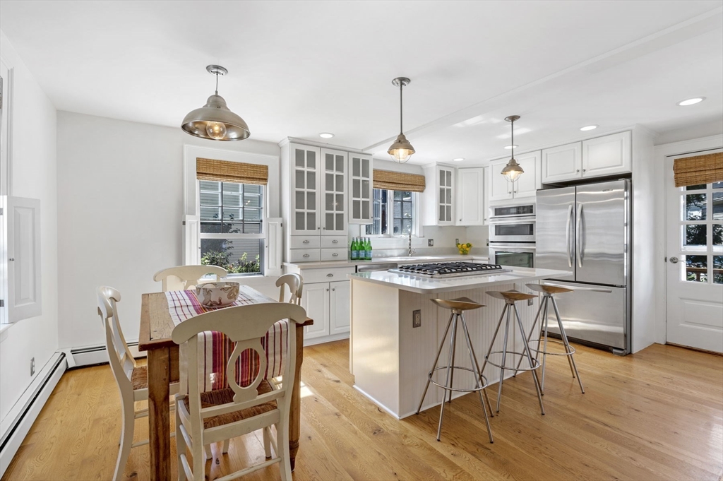 34 Front Street Marblehead, MA 01945 - Photo 14 of 41 a kitchen with stainless steel appliances granite countertop a stove a refrigerator a kitchen island a table and chairs