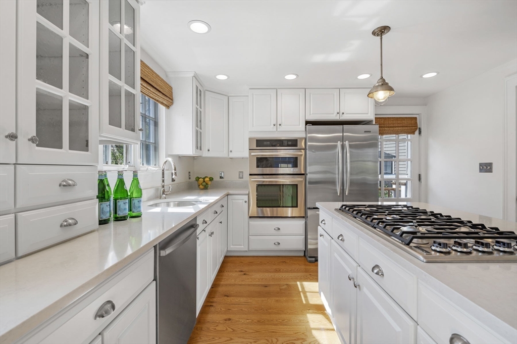 34 Front Street Marblehead, MA 01945 - Photo 15 of 41 a kitchen with stainless steel appliances kitchen island granite countertop a stove and a sink