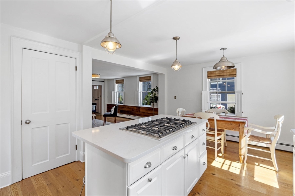 34 Front Street Marblehead, MA 01945 - Photo 19 of 41 a kitchen with stainless steel appliances granite countertop a stove a sink dishwasher and white cabinets with wooden floor