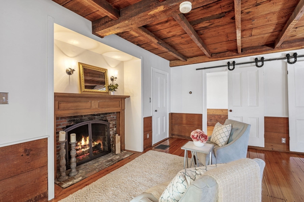 34 Front Street Marblehead, MA 01945 - Photo 26 of 41 a living room with furniture a fireplace and a table