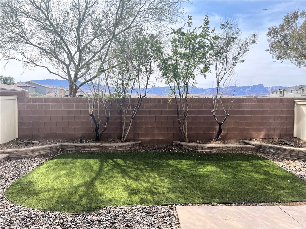9535 Leaping Lizard Street Las Vegas, NV 89178 - Photo 22 of 37 View of yard featuring a mountain view and a fenced backyard
