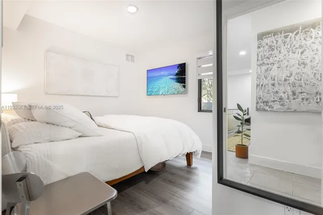 a bedroom with a bed and a painting on the wall