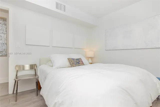 a bedroom with a bed and chair