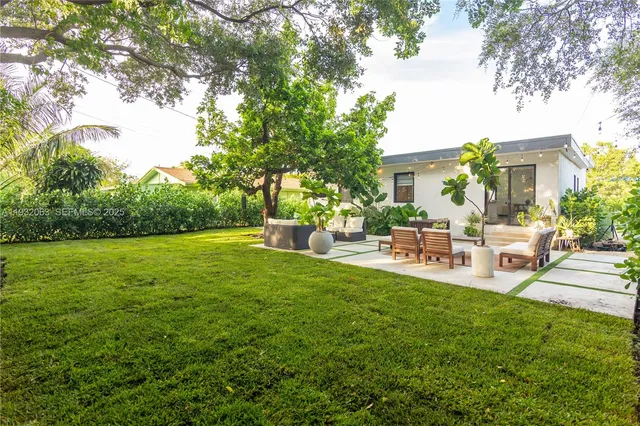 a view of a backyard with sitting area