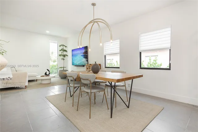 a living room with furniture a window and a table