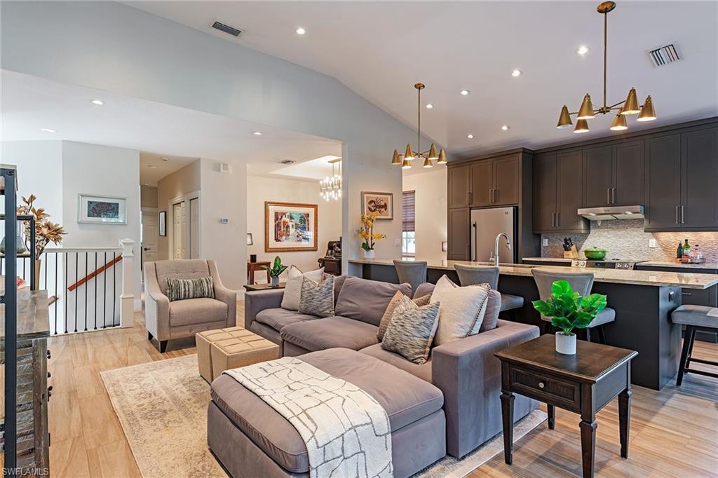 7115 Wild Forest Court, Unit 201 Naples, FL 34109 - Photo 3 of 18 a living room with furniture and wooden floor