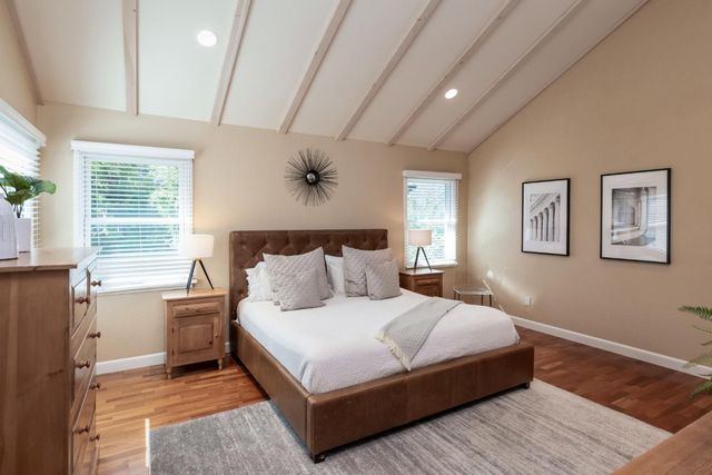 a bedroom with a large bed and a window