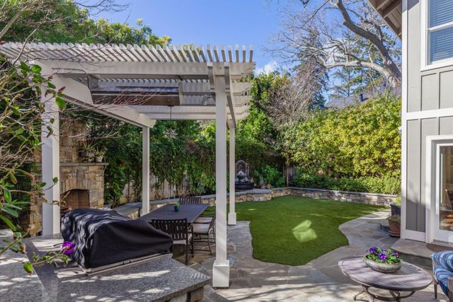 a view of a patio with table and chairs potted plants