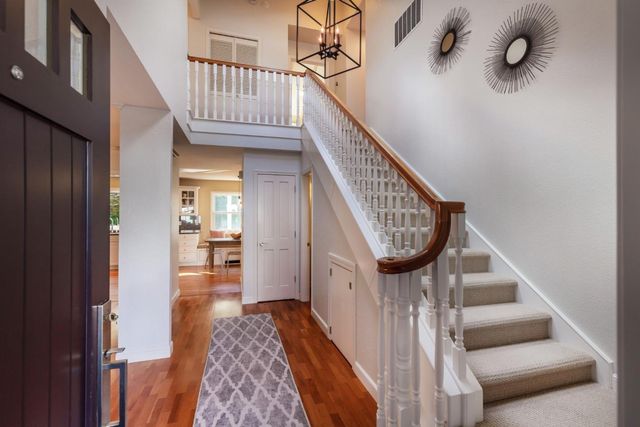 a view of staircase with lots of frames on wall and stairs