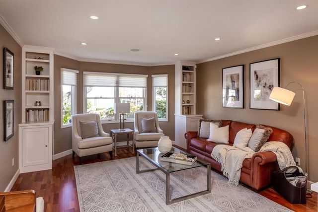 a living room with furniture and large windows