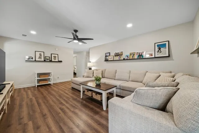 a living room with furniture and wooden floor
