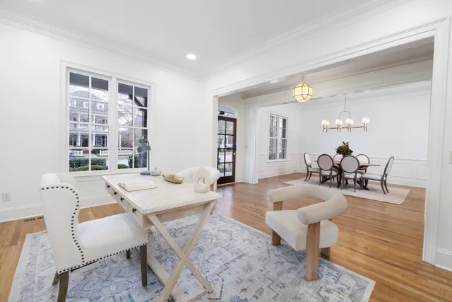 a view of a dining room with furniture a chandelier and wooden floor