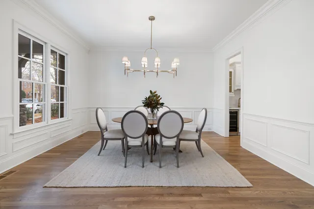 a view of a dining room with furniture wooden floor and chandelier