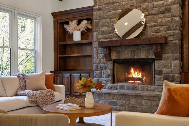 a kitchen with a dining table chairs refrigerator and cabinets