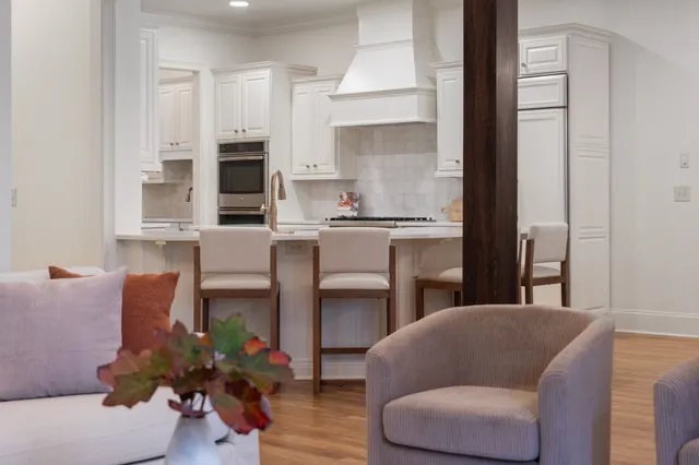 a kitchen with white cabinets and sink