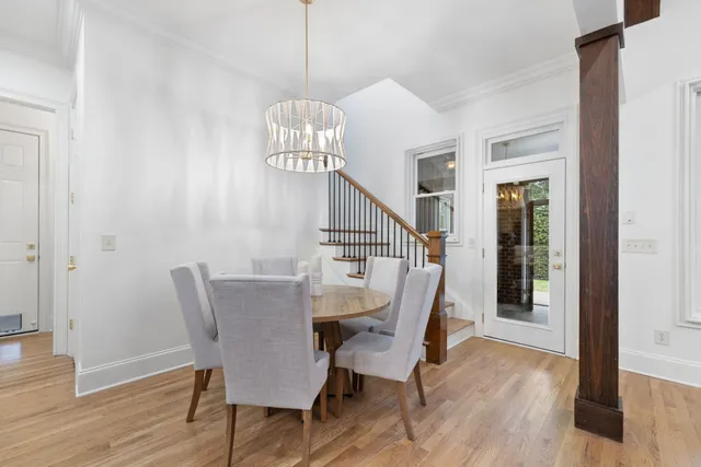 a view of a big room with wooden floor and windows