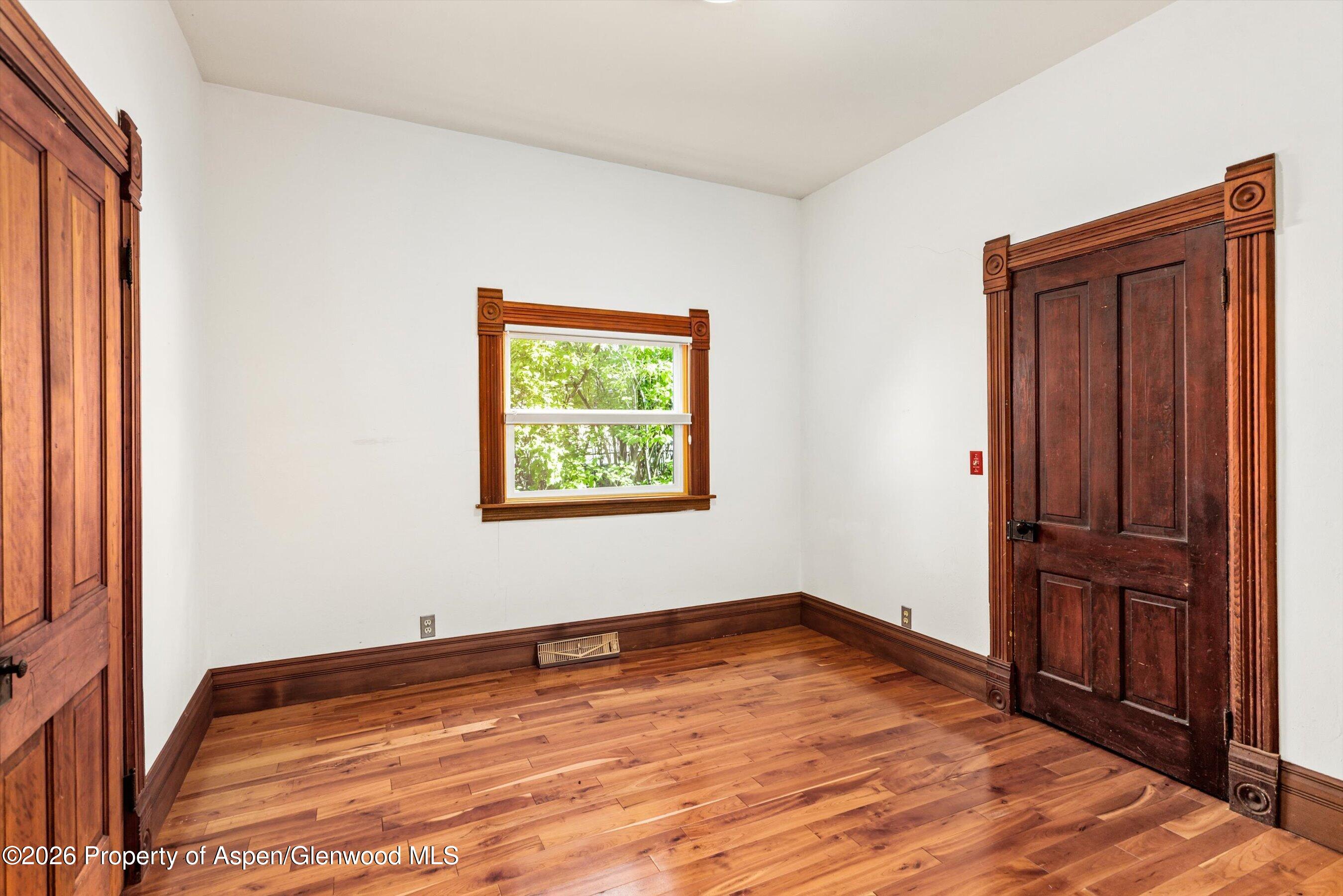 235 East Homestead Drive Basalt, CO 81621 - Photo 13 of 38 an empty room with wooden floor and window