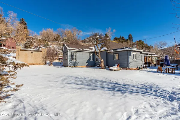 a view of a house with a snow in the background