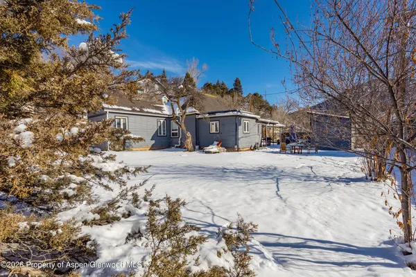 a view of large house with a snow on the road
