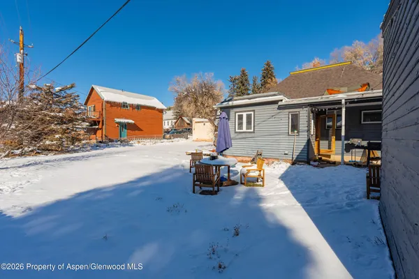 a view of a backyard with sitting area