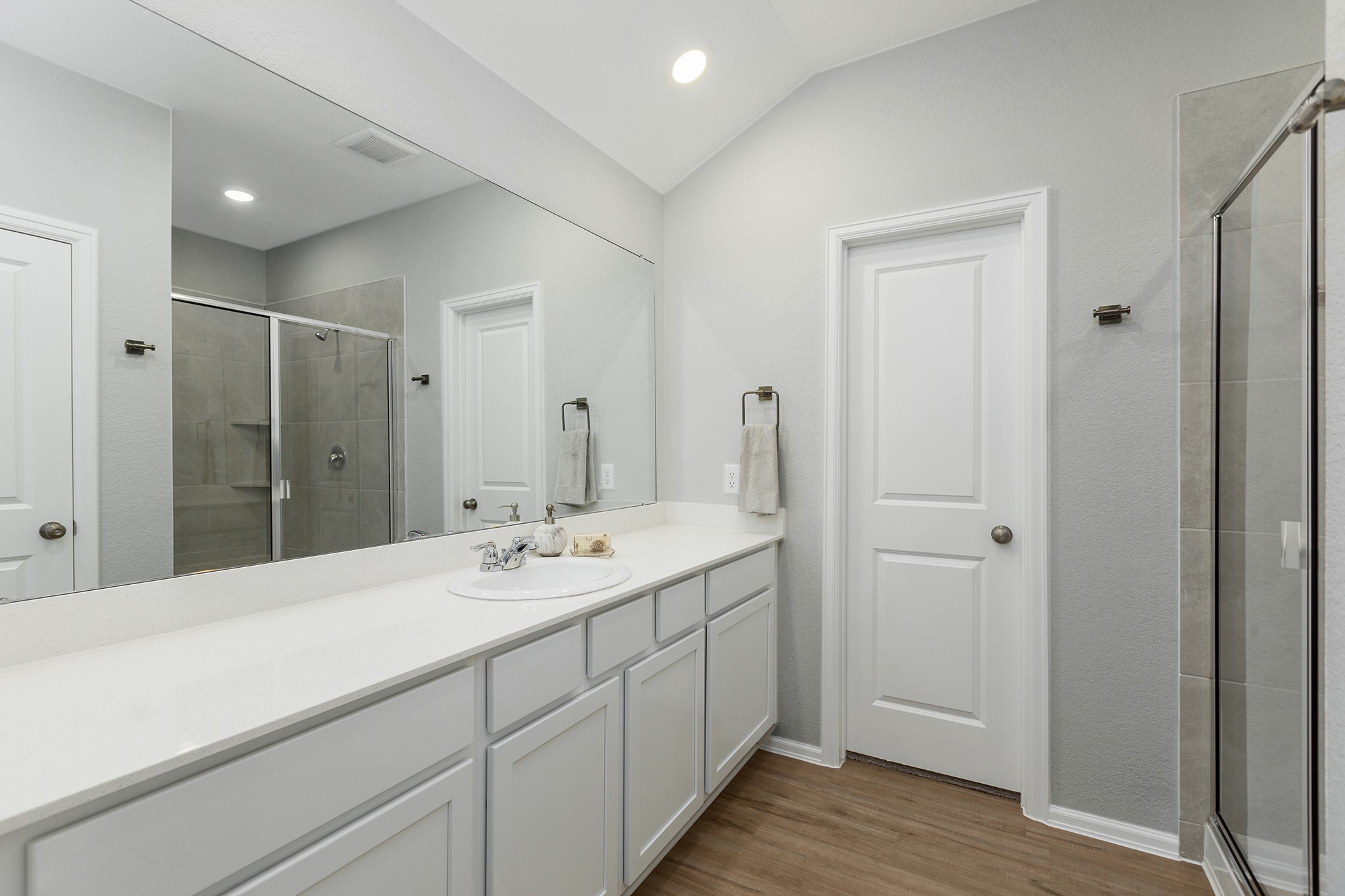 6327 Arcadia Sound Lane Houston, TX 77365 - Photo 16 of 33 a spacious bathroom with a shower sink and mirror