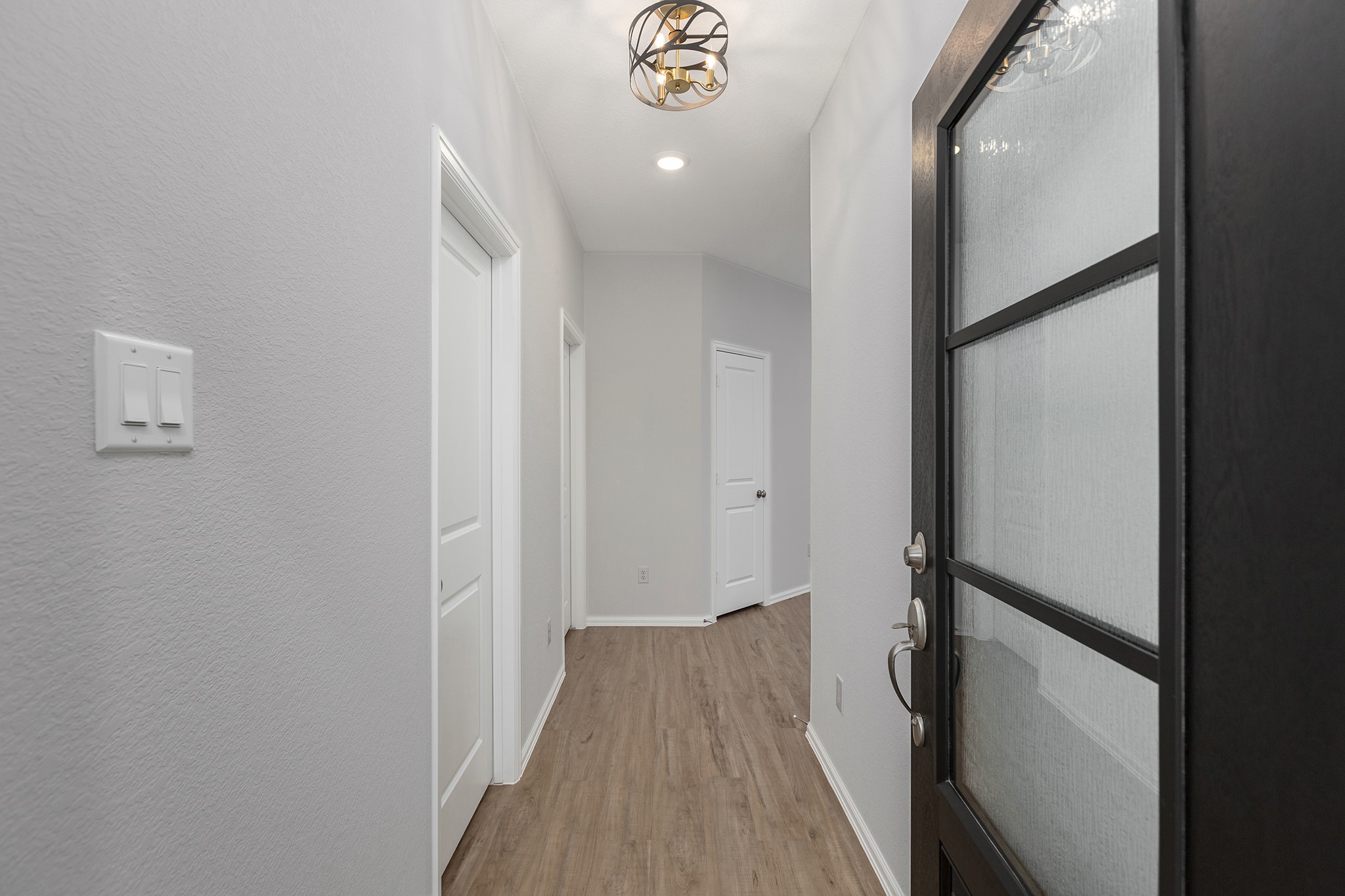 6327 Arcadia Sound Lane Houston, TX 77365 - Photo 4 of 33 a view of a hallway with wooden floor