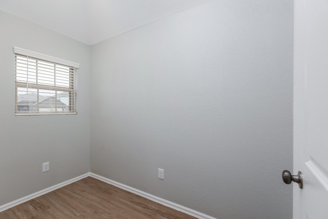 6327 Arcadia Sound Lane Houston, TX 77365 - Photo 5 of 33 a view of a small space with wooden floor and a window