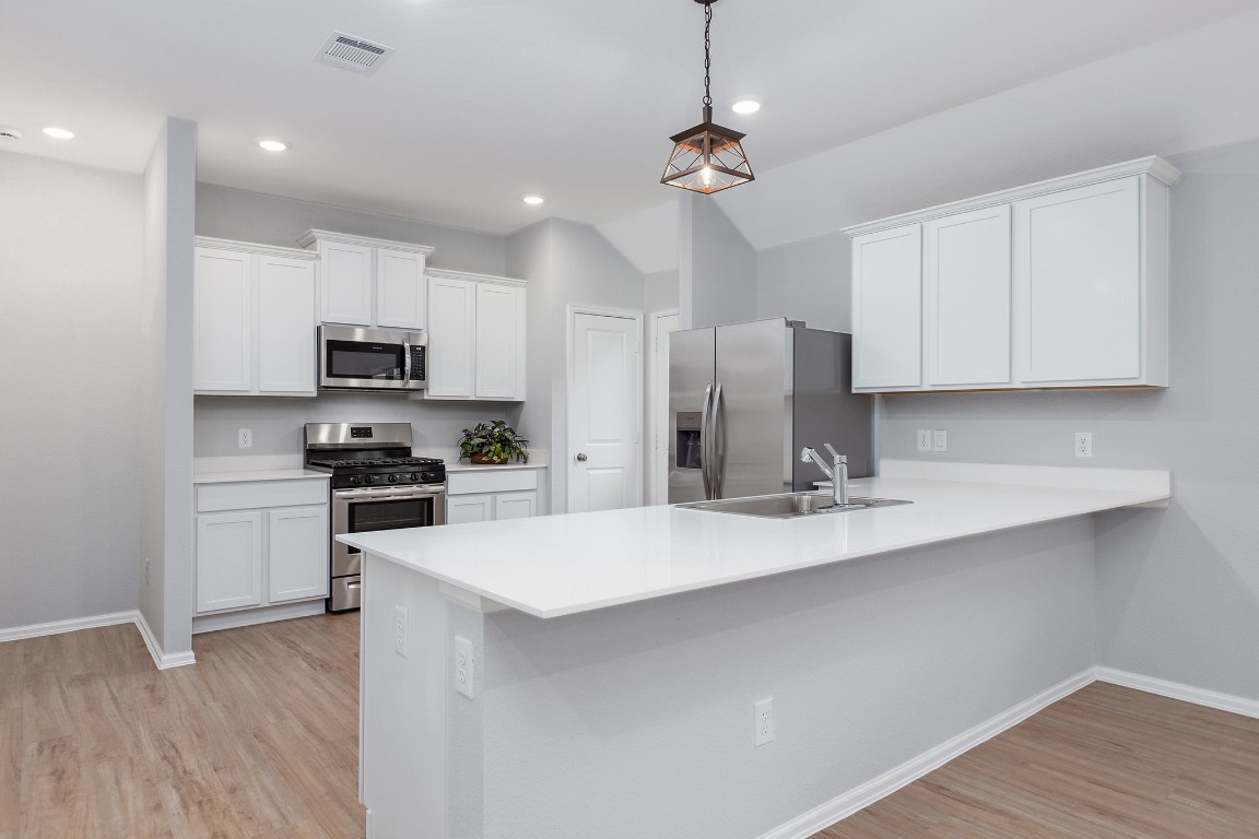 6327 Arcadia Sound Lane Houston, TX 77365 - Photo 6 of 33 a kitchen with stainless steel appliances a refrigerator sink and microwave