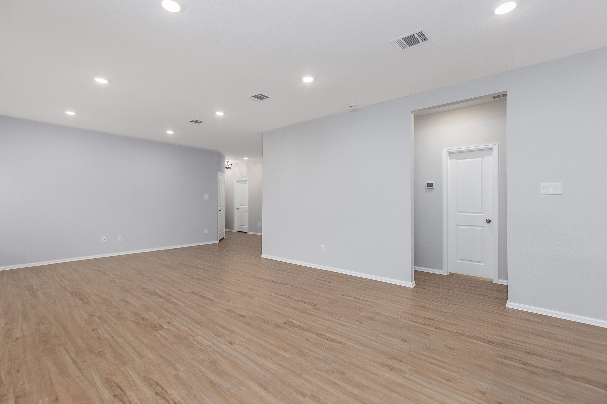 6327 Arcadia Sound Lane Houston, TX 77365 - Photo 10 of 33 a view of an empty room with wooden floor