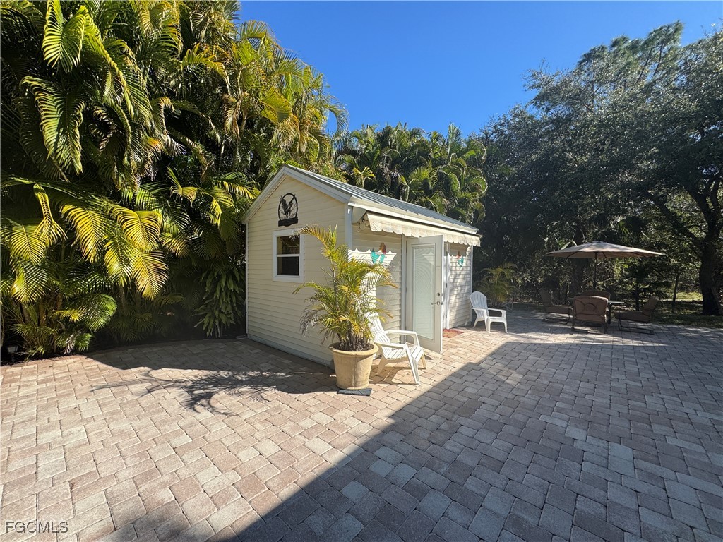 Lot 212-3027 Belle Of Myers Road LaBelle, FL 33935 - Photo 12 of 43 a view of a backyard with table and chairs with wooden fence