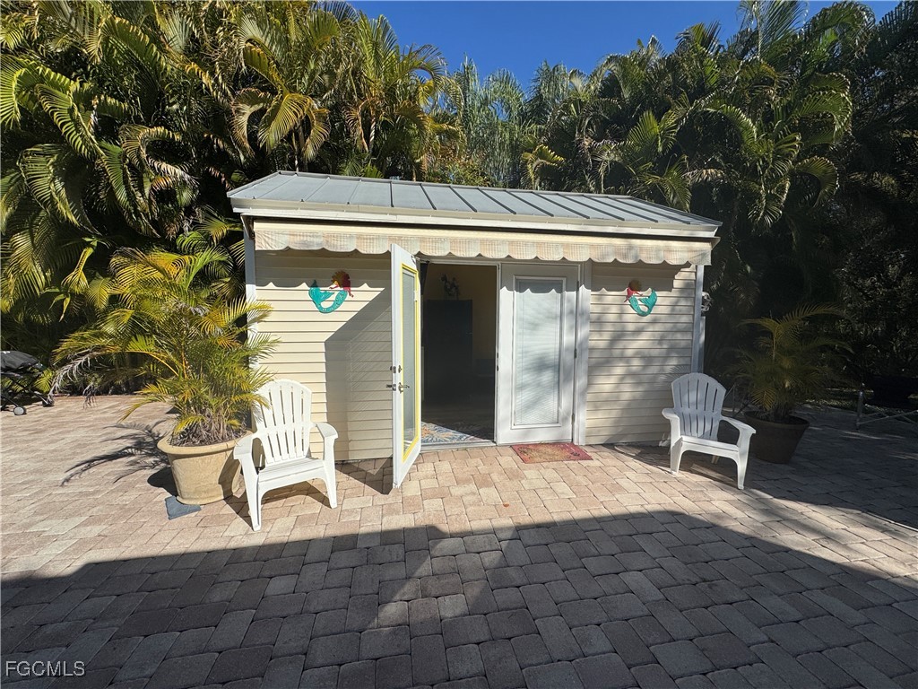 Lot 212-3027 Belle Of Myers Road LaBelle, FL 33935 - Photo 14 of 43 a view of a patio with table and chairs with wooden floor and fence