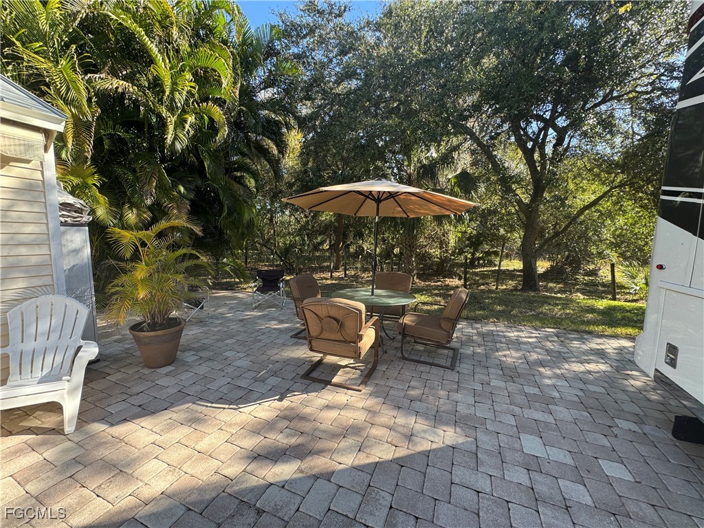 Lot 212-3027 Belle Of Myers Road LaBelle, FL 33935 - Photo 15 of 43 a view of a patio with chairs and potted plants
