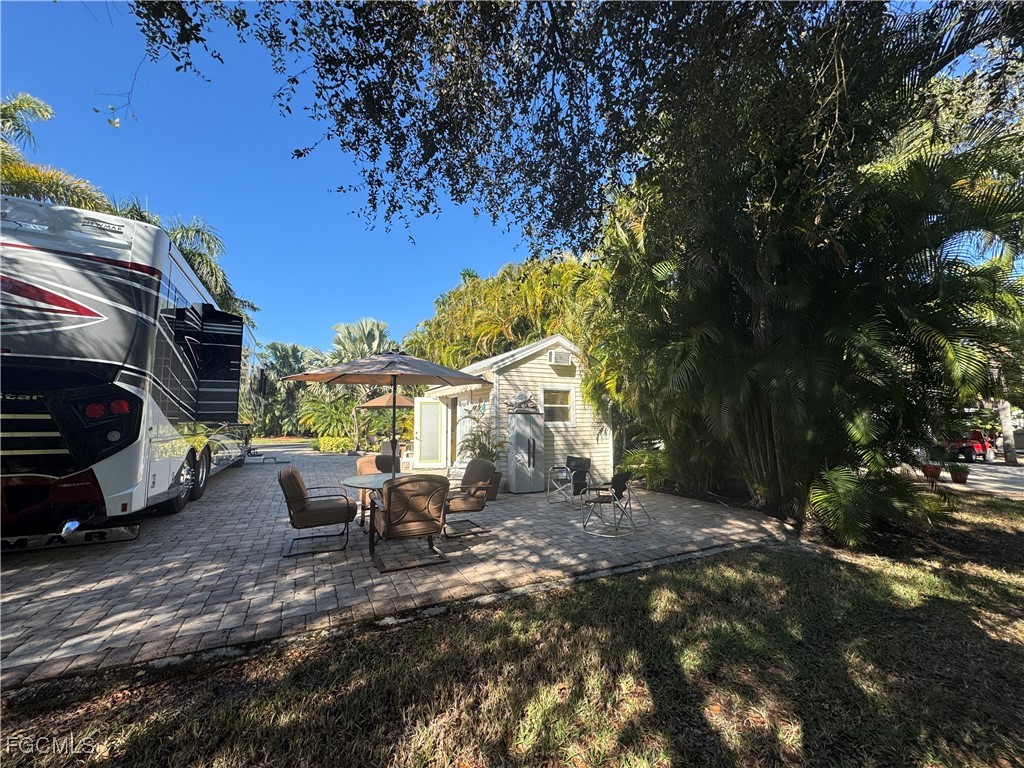 Lot 212-3027 Belle Of Myers Road LaBelle, FL 33935 - Photo 20 of 43 a view of a patio with table and chairs and potted plants