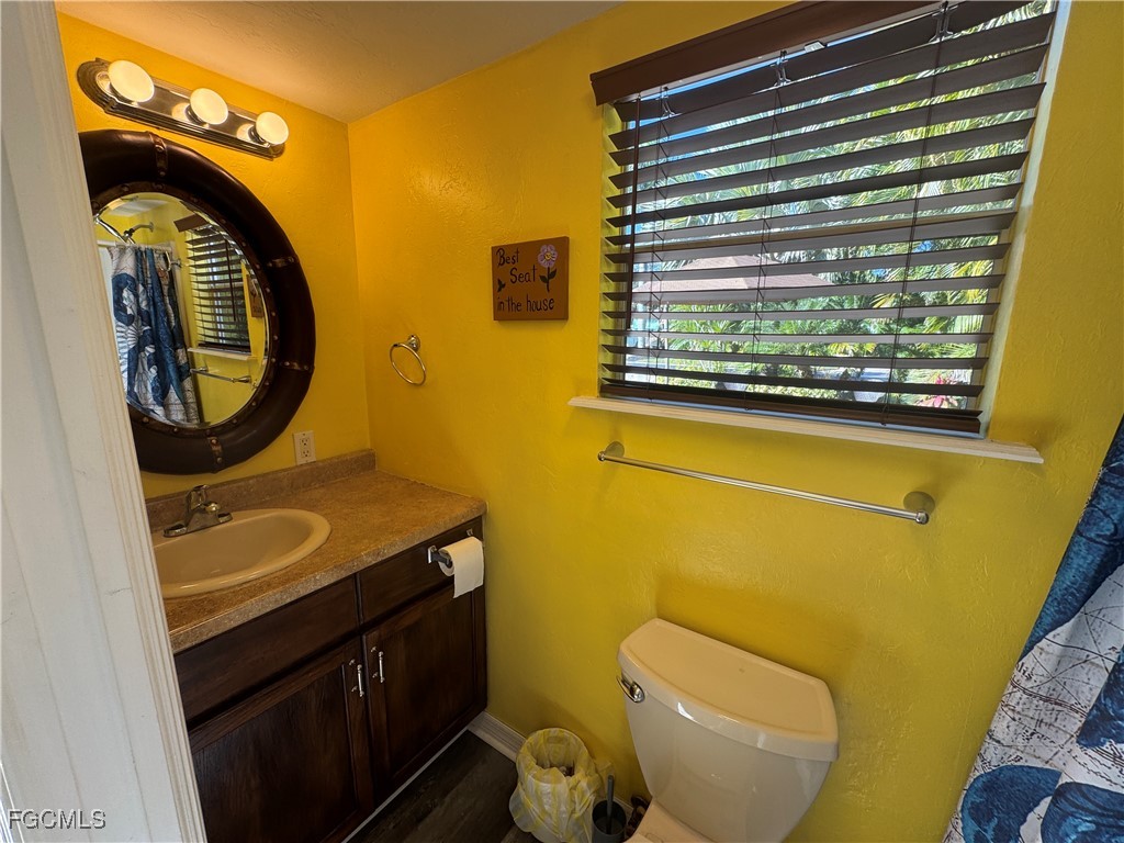 Lot 212-3027 Belle Of Myers Road LaBelle, FL 33935 - Photo 31 of 43 a bathroom with a granite countertop toilet sink and mirror