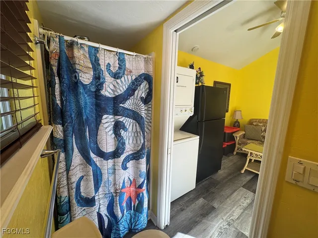 a view of a room with wooden floor and a rug
