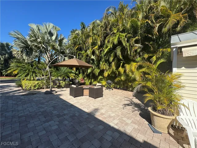 a view of a backyard with sitting area