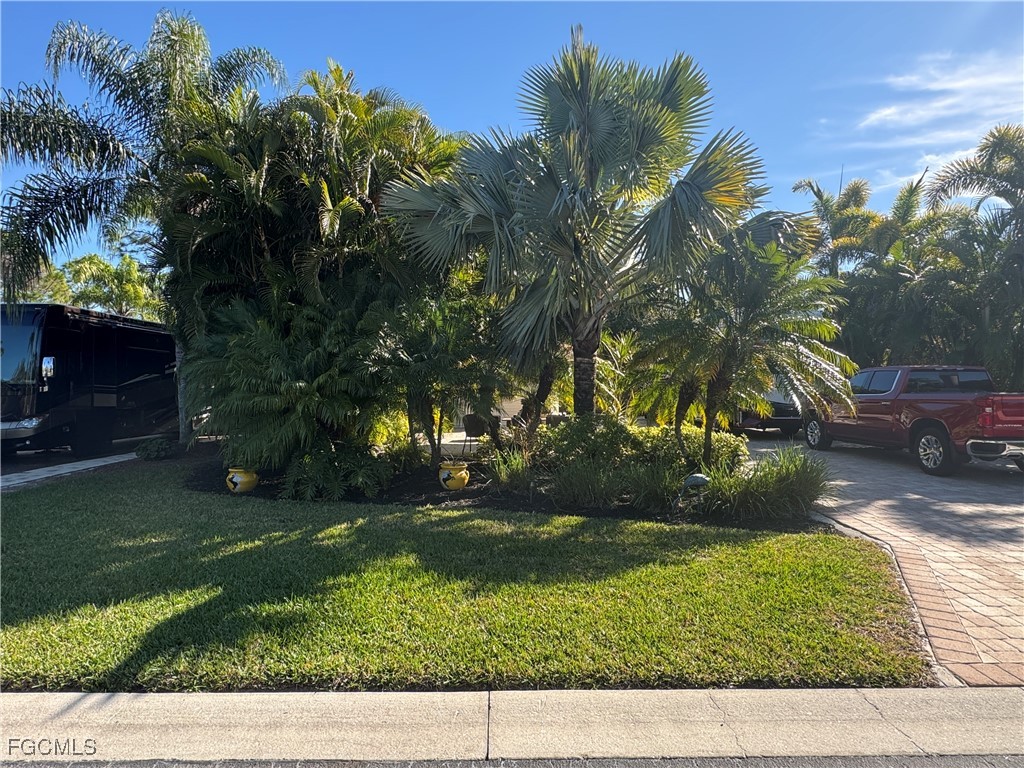 Lot 212-3027 Belle Of Myers Road LaBelle, FL 33935 - Photo 4 of 43 a backyard of a house with lots of green space